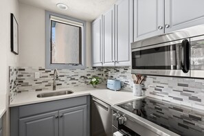 A modern kitchen with a stainless steel refrigerator, a microwave, and a toaster. - Townhome across the street from Base Village! (Snowmass Village)
