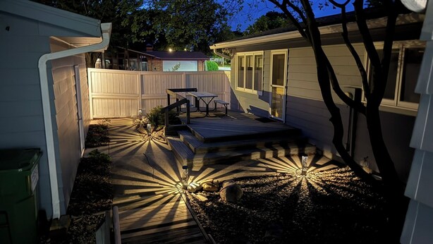 A backyard with a wooden deck, a picnic table, and a small shed. - Sleeps 10 - 5BR - Minutes to Campus - Next to Park, Golf, Shopping (Ames)