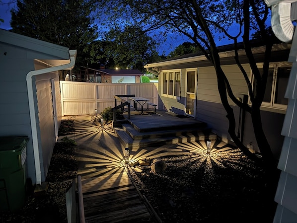 A backyard with a wooden deck, a picnic table, and a small shed. - Sleeps 10 - 5BR - Minutes to Campus - Next to Park, Golf, Shopping (Ames)