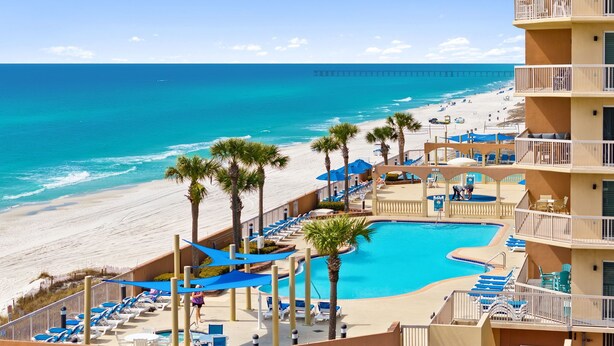 Un hotel frente a la playa con piscina, acceso directo a la playa y vistas al océano.