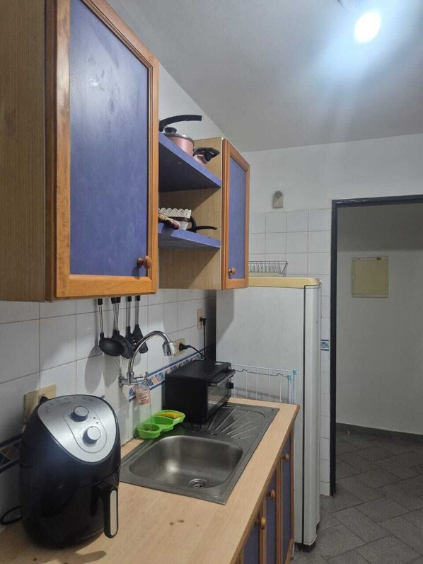 A kitchen with a built-in oven, a sink, and a countertop.