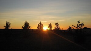 A rural landscape with a road leading to a sunset. - Delightful 6-bedroom house in tranquil city of Puerto Varas perfect for families (Los Lagos)