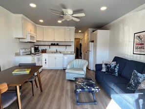 A compact living space with a kitchenette, a dining area, a sofa, and a small coffee table. - Oceanview Beachfront Condo Sleeps 6. Pool& Tennis Courts (Hilton Head Island)
