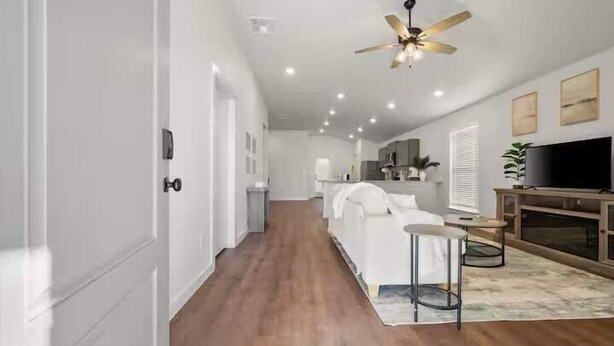 A modern living room with a sofa, coffee table, and TV. - Langford House - 3BR/2BA - Family Friendly (Lubbock)