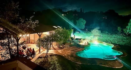 Winnebago camper set up on beautiful property with resort style pool and jacuzzi