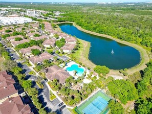 A residential area with houses, a swimming pool, and a tennis court. - 2723 Condo Near Disney with  2BR & Private Balcony (Kissimmee)