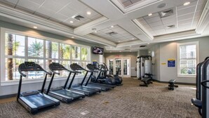 A gym with treadmills, exercise balls, and a weight bench. - 7BR Resort Pool Home Near Disney - 8004 (Davenport)
