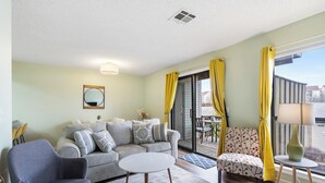 A living room with a sofa, armchairs, a coffee table, and a lamp. - Stylish Branson Retreat with Golf and Amenities (Branson)