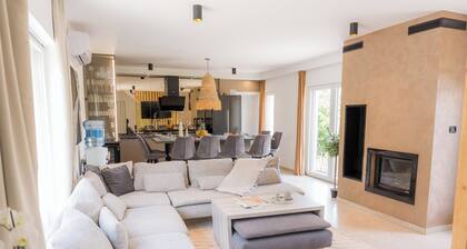 Luxurious riverside retreat with pool, sauna, jacuzzi, and panoramic nature views.