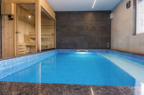 Luxurious riverside retreat with pool, sauna, jacuzzi, and panoramic nature views.
