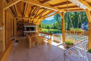 Outdoor dining - Eco-friendly mountain retreat with pool, jacuzzi, sauna, and panoramic Velebit views. (Gospić)