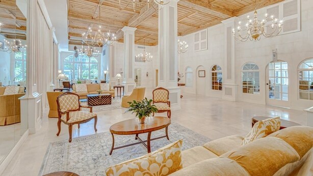 A spacious lobby with high ceilings, chandeliers, and a large seating area. - Palm Breeze Palm Beach Island Studio Heated Pool (Palm Beach)