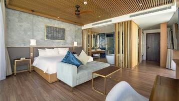 A modern hotel room with a wooden ceiling, a large bed with white linens, a grey sofa, and a small table.