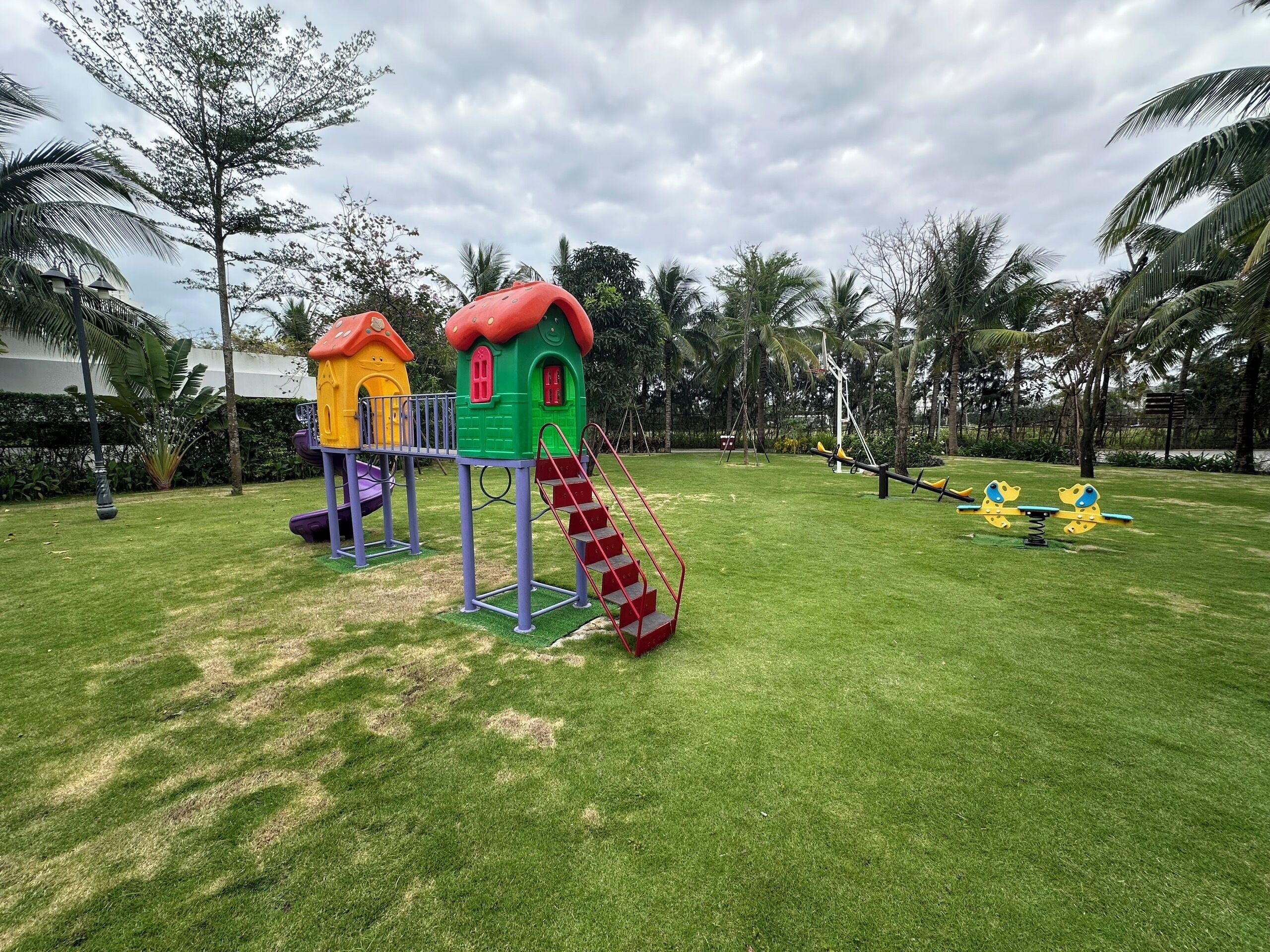 A playground with a slide, climbing structures, and swings.