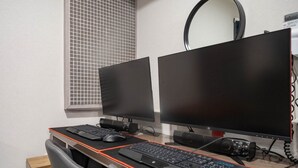 A dual-monitor workstation with two keyboards, a mouse, and a camera. - MORASTAY (Busan)