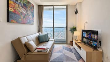 Apartment, 2 Bedrooms, City View | Living area | 43-inch Smart TV with cable channels