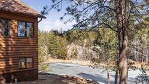 A log cabin with a view of a lake and surrounding forest. - Beaver Lake Pond & Pines Cabin (Custer)