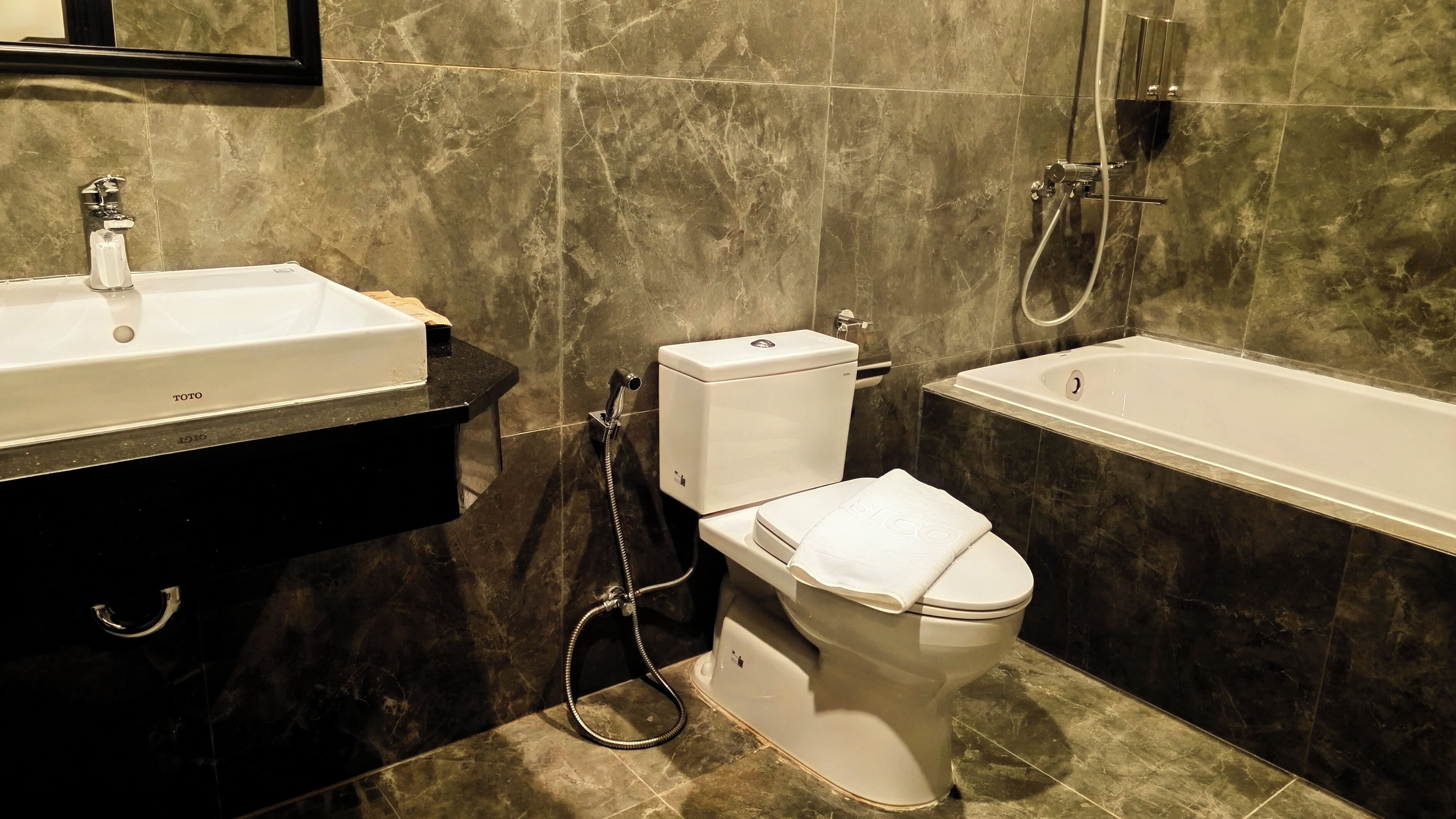 A bathroom with a toilet, a sink, and a bathtub.