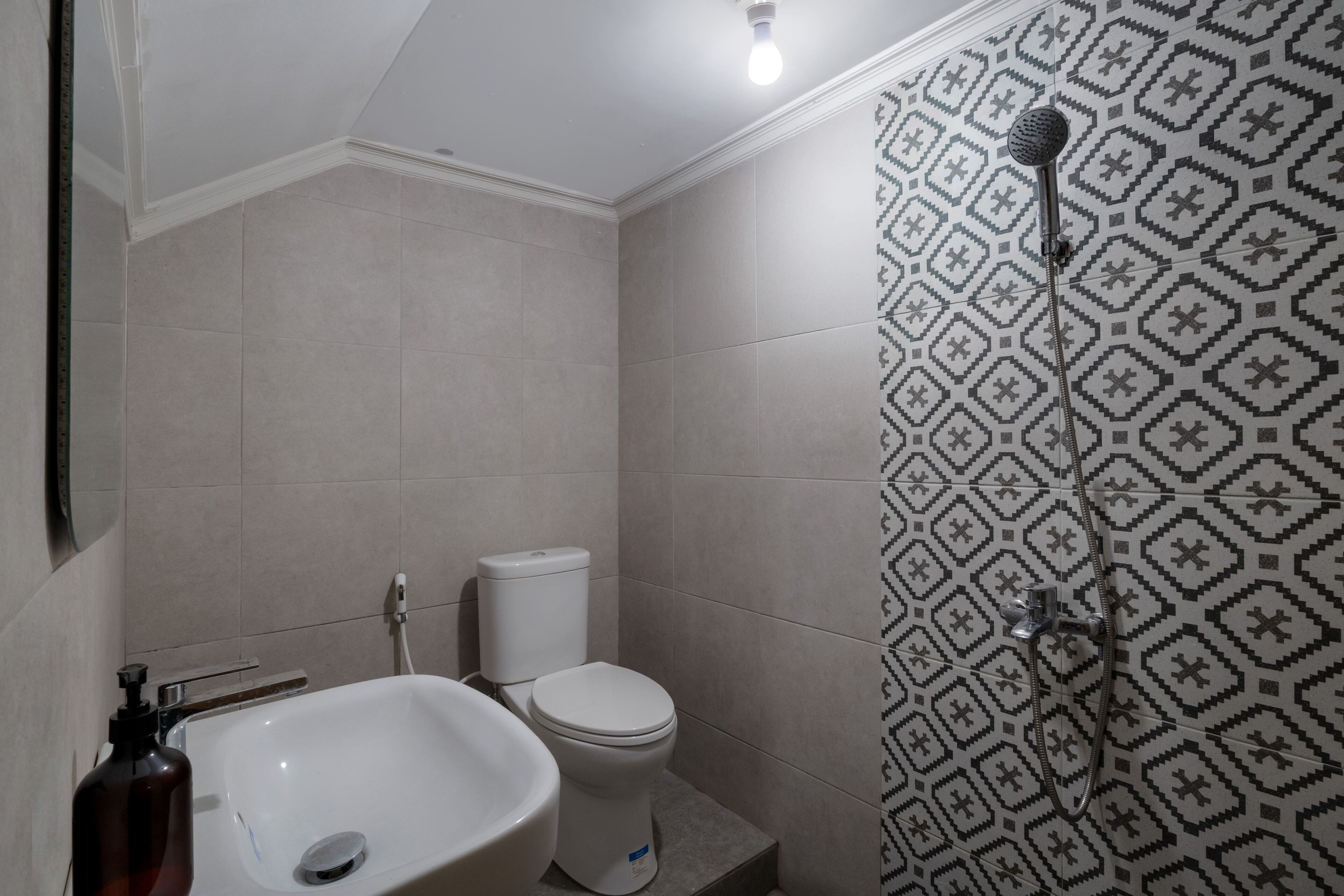 A bathroom with a sink, toilet, and shower.