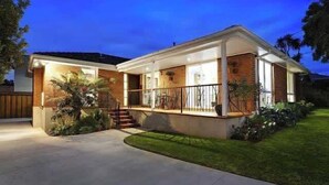 A modern two-story house with a covered porch, a brick exterior, and a well-maintained lawn. - Puddings Home Wheelers Hill A/C WiFi Garden (Wheelers Hill)