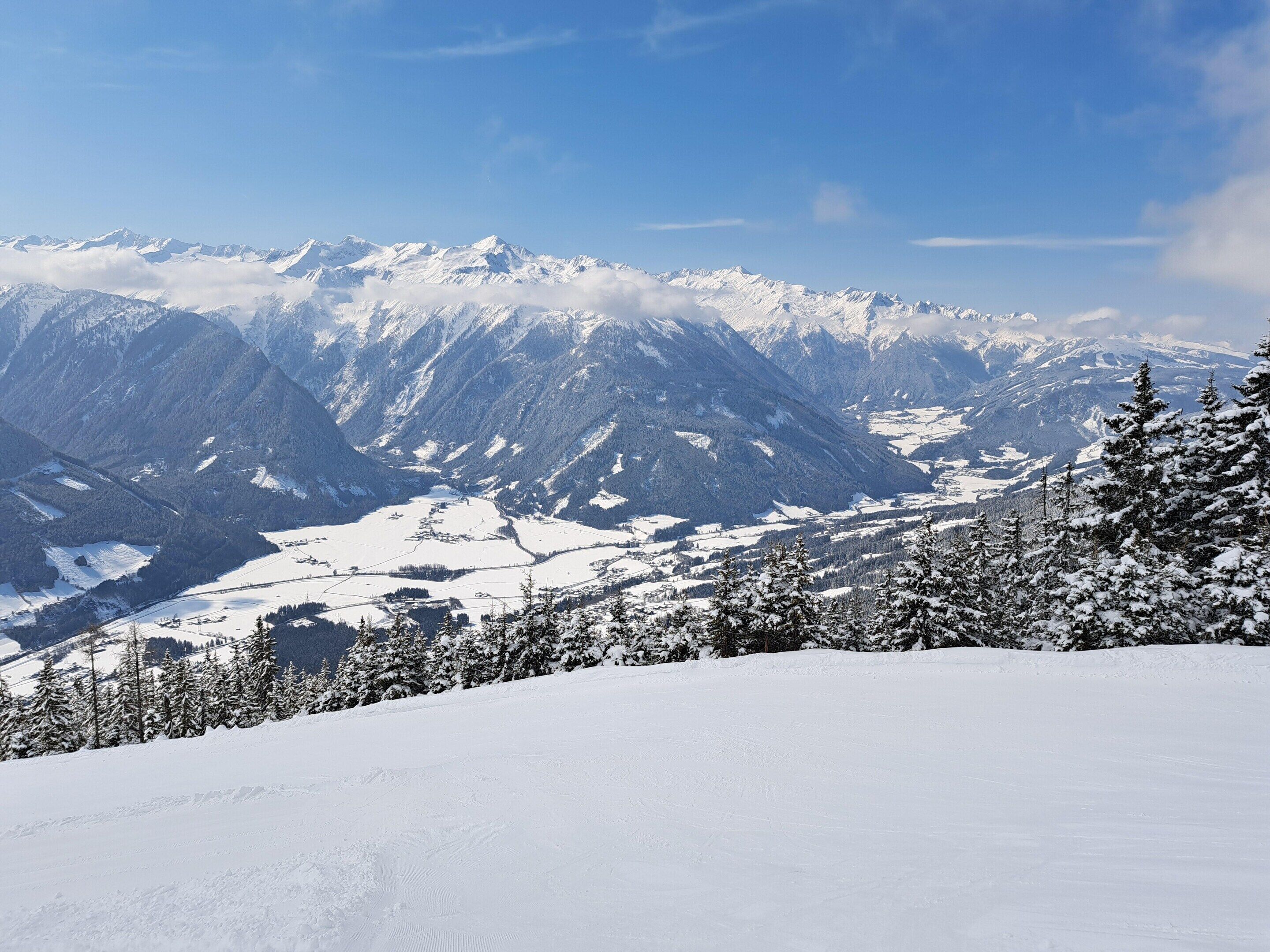 A snow-covered mountain landscape with a clear sky.