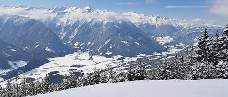 A snow-covered mountain landscape with a clear sky.