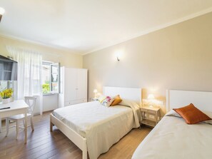 A bedroom with two beds, a desk, and a wardrobe. - Podere Galieni by Interhome (Certaldo)