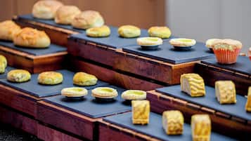 A variety of pastries displayed on wooden stands.