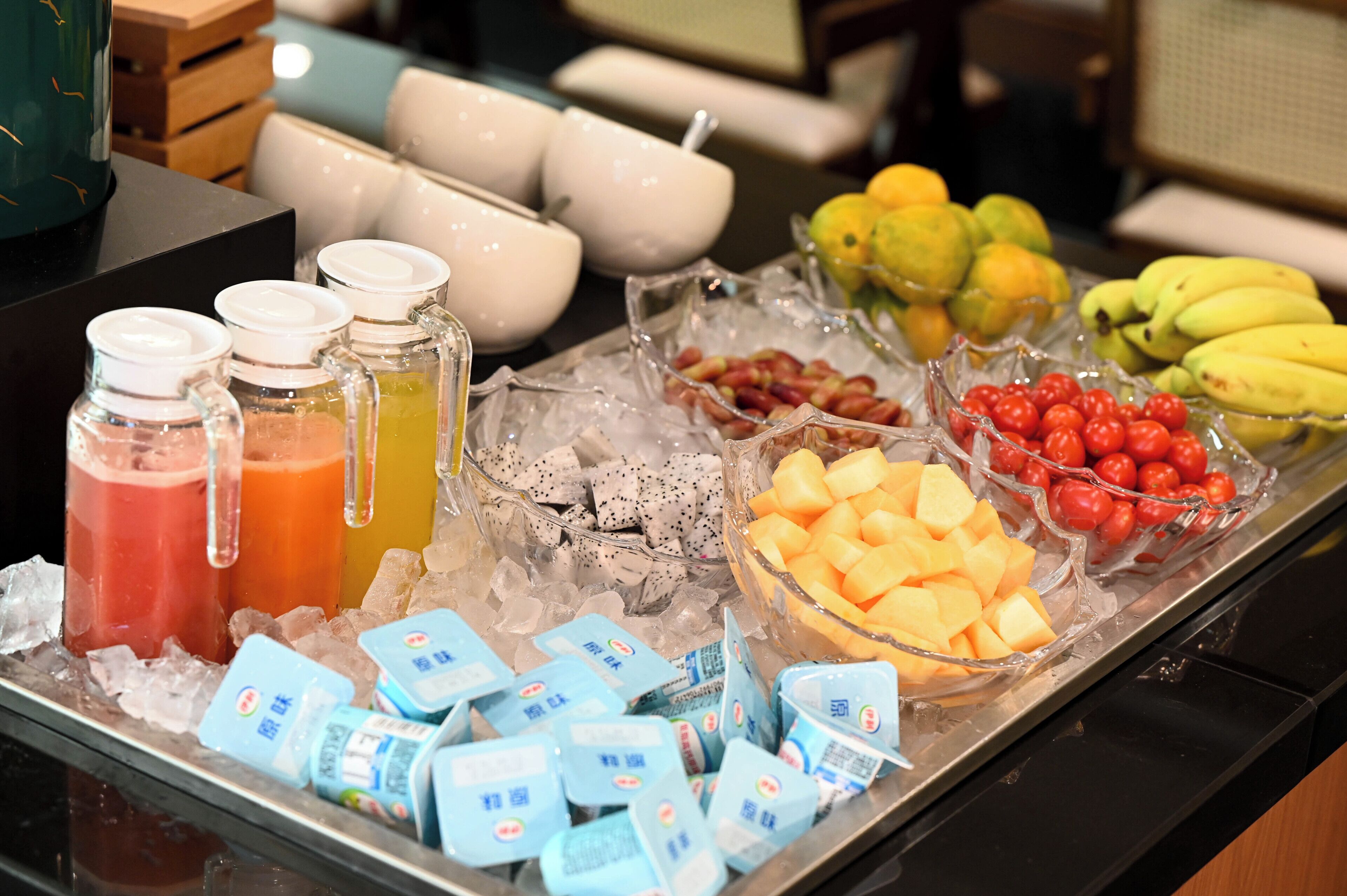 A buffet with various food items and beverages on a tray.
