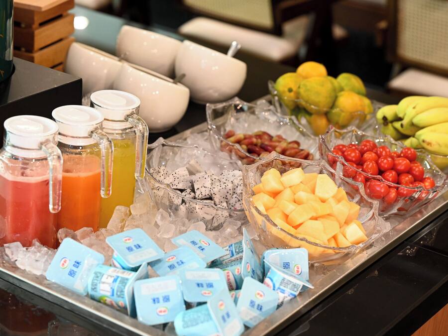 A buffet with various food items and beverages on a tray.