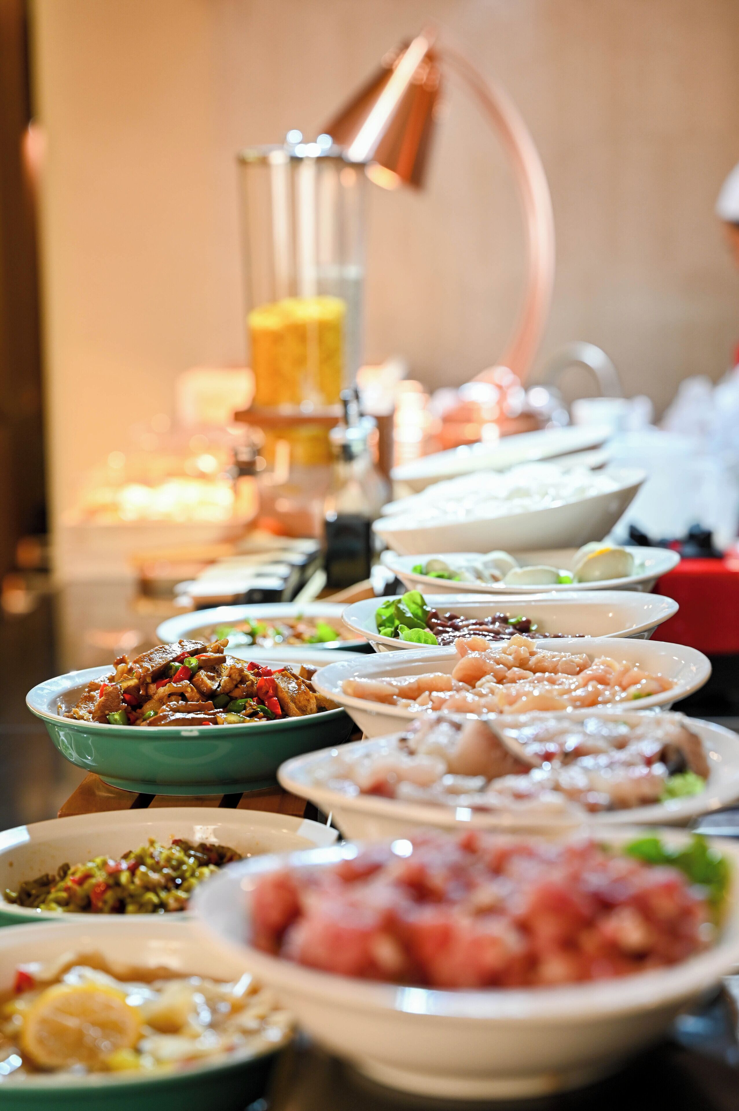 A buffet table with various dishes.