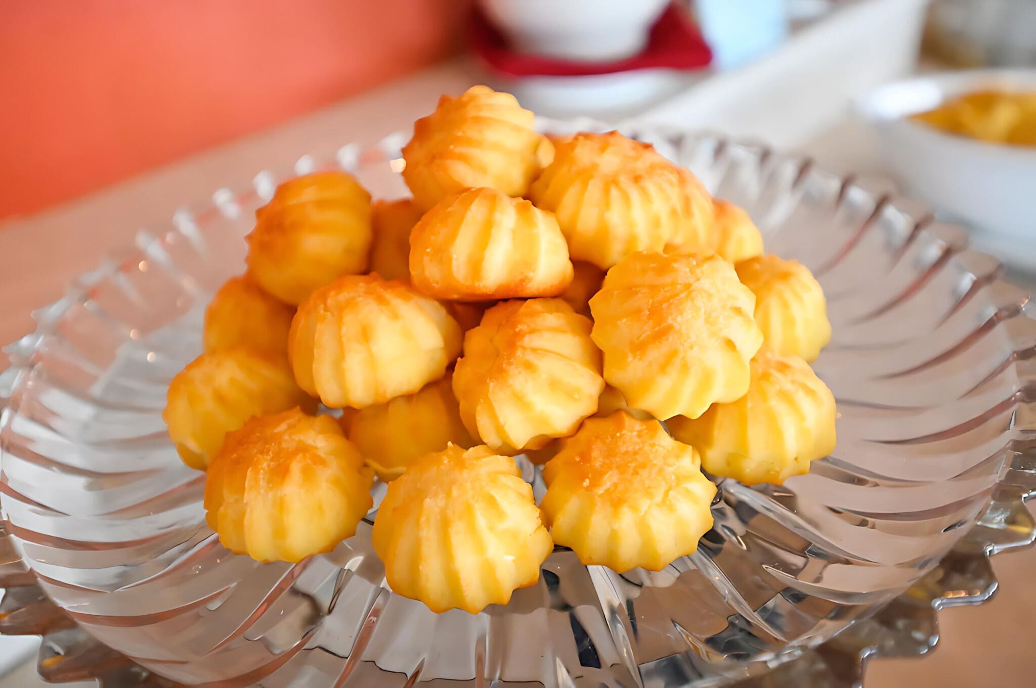 A clear glass bowl filled with golden-brown pastries.
