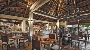 A spacious restaurant with high ceilings and a bar area. - Spacious 4-Bedroom Villa / Infinity Pool & Peaceful Bel Ombre Setting (Bel Ombre)