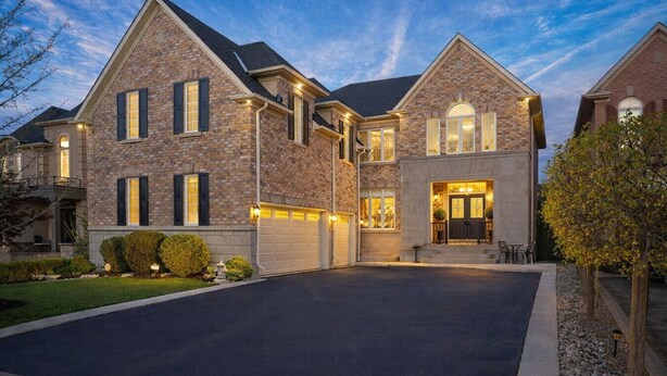 A large, two-story house with a garage, a well-maintained lawn, and a driveway. - Above-Ground · Sun-Filled · Not a Basement · Your Own Private Entrance (Brampton)