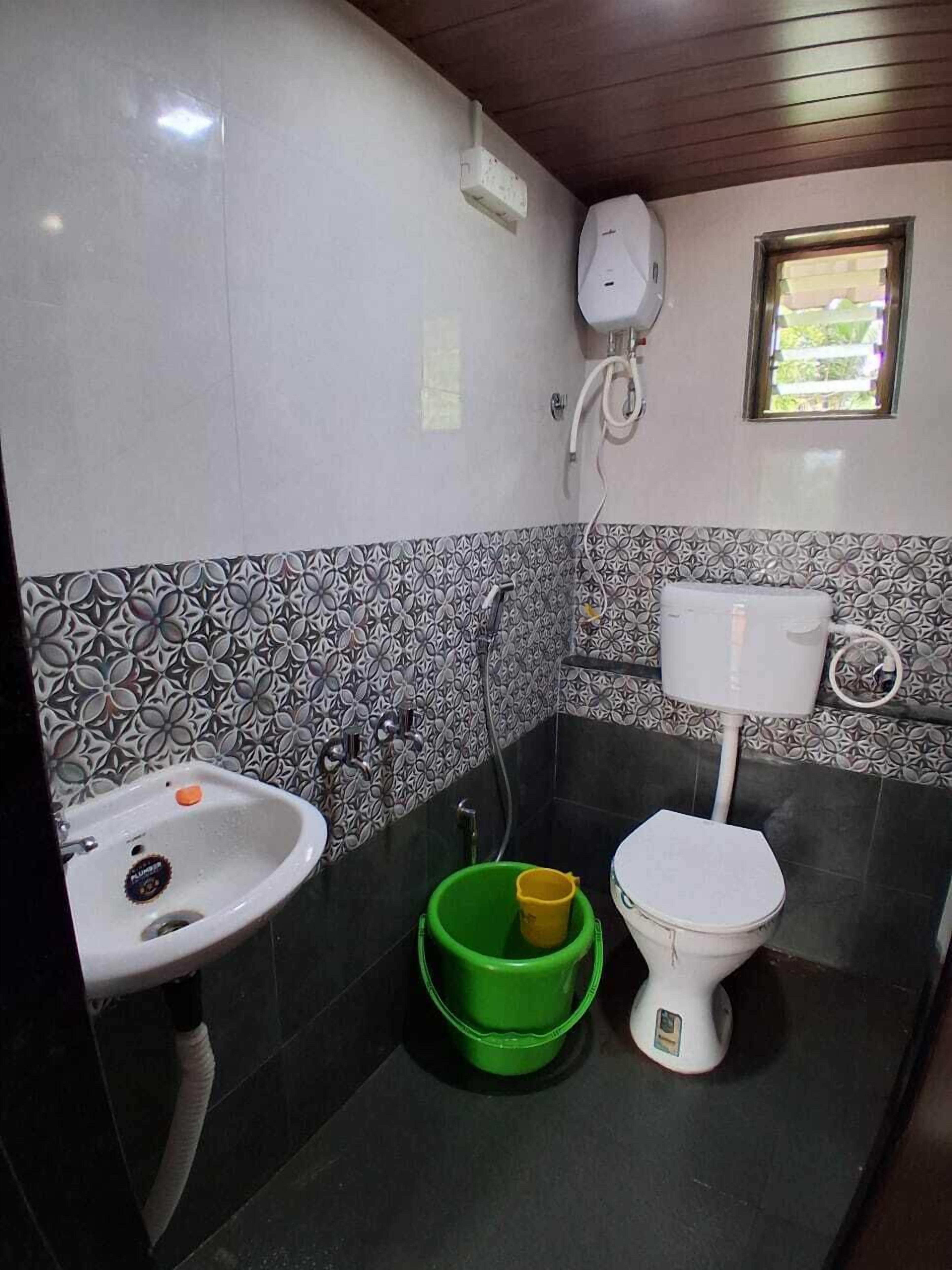 A small bathroom with a sink, toilet, and shower.
