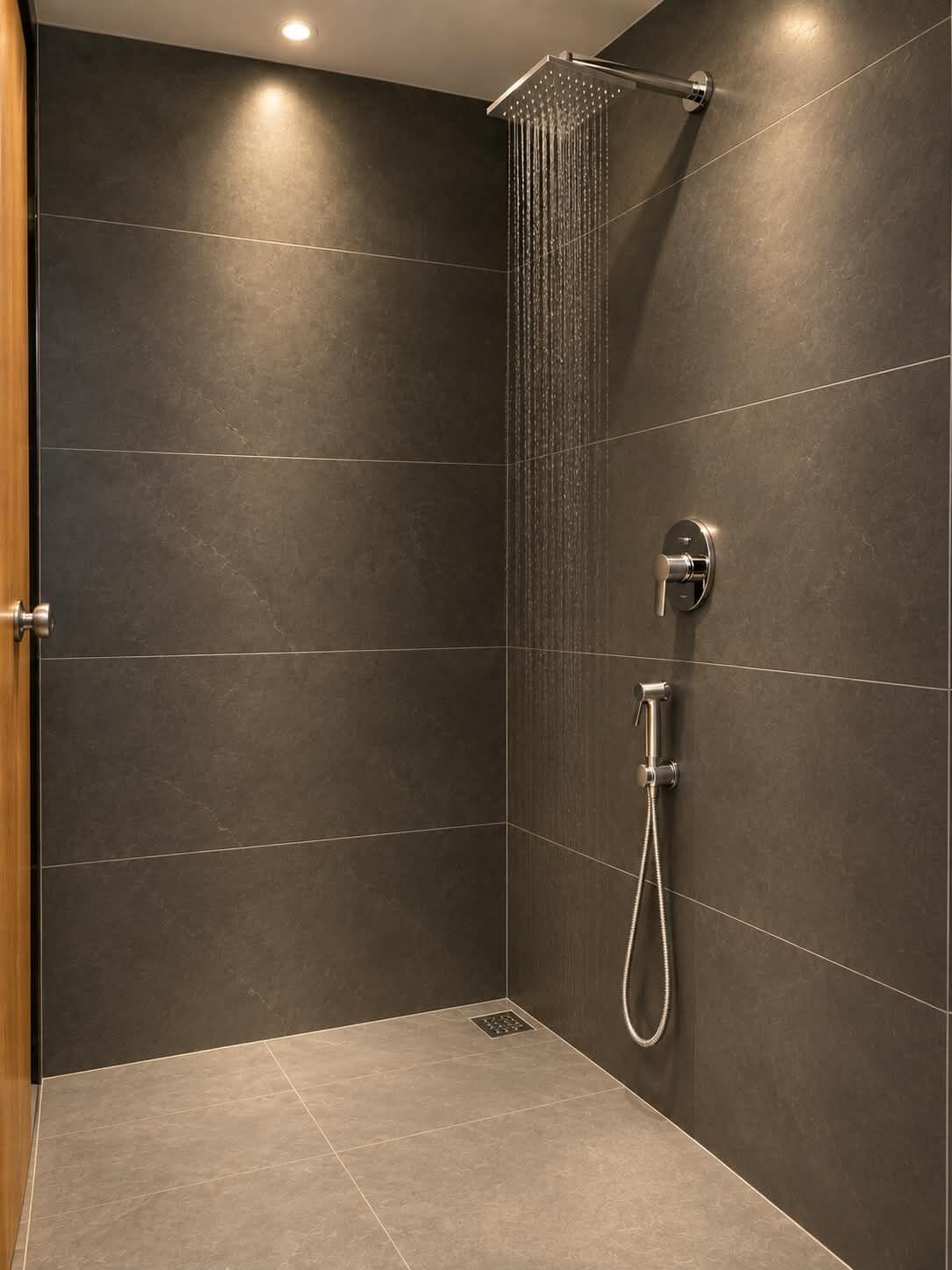 A modern shower area with a rain showerhead and handheld shower attachment.