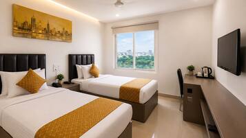 A hotel room with two beds, a large window, a flat-screen TV, and a cityscape painting.