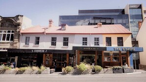A building with a storefront named 'The Stagg' and another named 'Monks & Co.' - The Funky Den on Warwick (Hobart City)