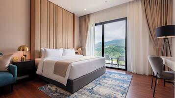 Deluxe Suite, 1 King Bed, Balcony | Desk, laptop workspace, blackout curtains, iron/ironing board