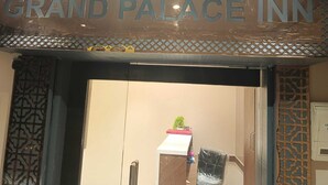 The entrance of the Grand Palace Inn with a sign above the door. - Hotel Grand Palace Inn (Mumbai)
