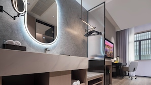 A modern bathroom with a large mirror, built-in shelves, and a vanity. - Dream Palace Ben Thanh Grand Hotel (Ho Chi Minh City)