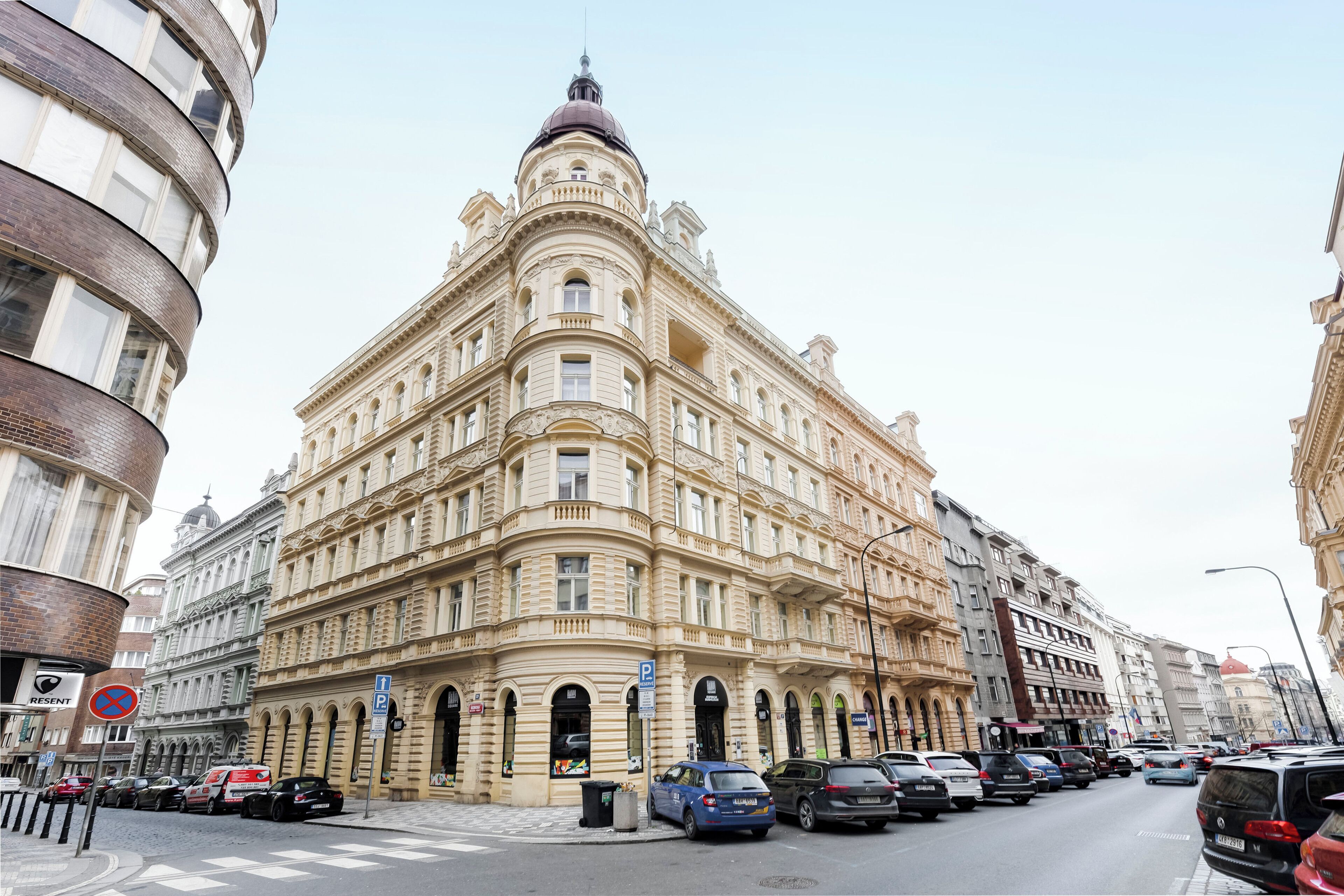 A historic building with classical architecture, featuring multiple floors, arched windows, and a prominent dome.