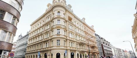 A historic building with classical architecture, featuring multiple floors, arched windows, and a prominent dome.