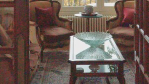 A room with a view of the sea, a glass-top table, two chairs, and a radiator. - Villa Jasmin (Veyrier-du-Lac)