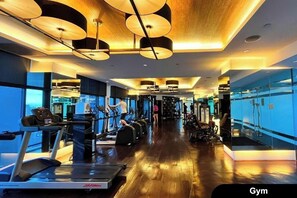 A gym with treadmills, elliptical machines, and weight equipment. - [KStayD]Studio,Best Sunset Pool/Luxury&Hotel Style (Makati)