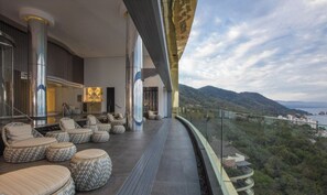 A modern outdoor lounge area with seating and a view of the landscape. - Luxury 2BR Sanctuary Retreat Overlooking Banderas Bay (Puerto Vallarta)