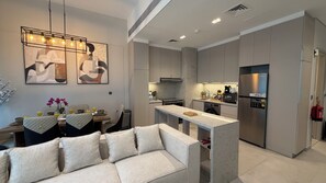 Luxury Apartment, Courtyard View | Living area | Flat-screen TV - Liva Suites By Hostiva - Dubai South (Dubai)