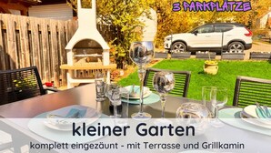 A small garden with a terrace and grill area, complete with outdoor dining setup. - Holiday Apartment "Auszeit Harz" – 3 Dogs Welcome, Fenced Garden, Private Guests Only (Bad Sachsa)