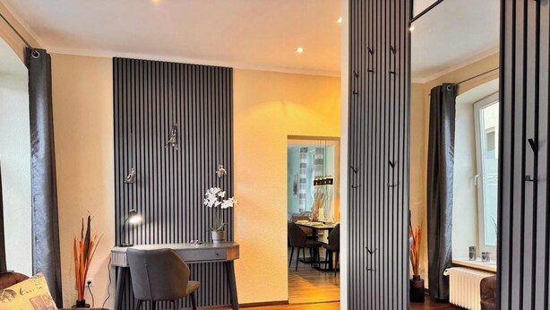 A modern interior with a dining area, a desk with a chair, and a large window. - Holiday Apartment "Auszeit Harz" – 3 Dogs Welcome, Fenced Garden, Private Guests Only (Bad Sachsa)