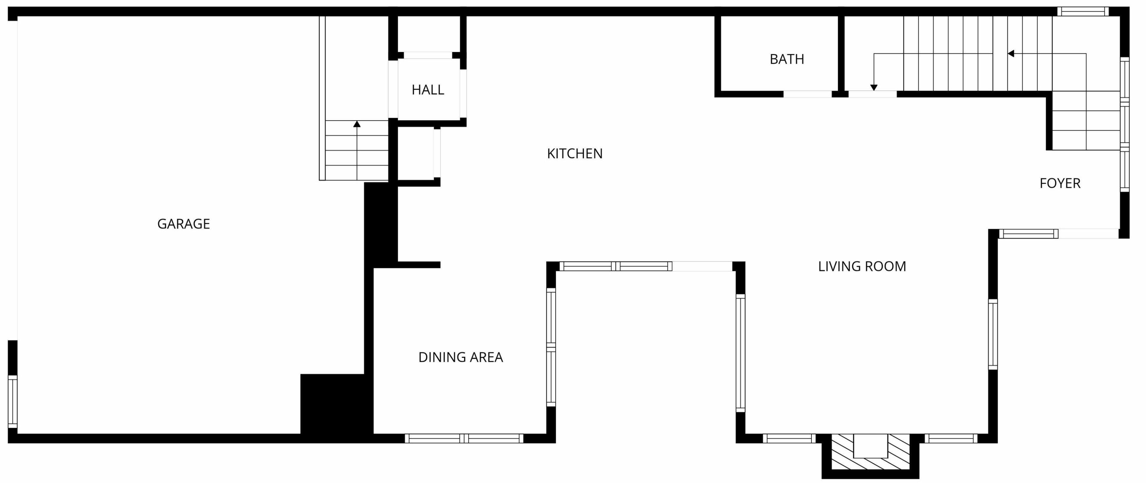 En planritning som visar ett garage, matplats, kök, hall, badrum, entré och vardagsrum.